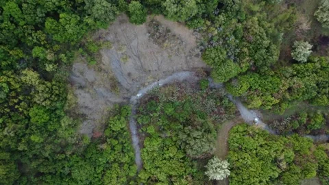 Aerial jungle river winding through steep cliffs and dense tropical vegetation Stock Footage 344096414