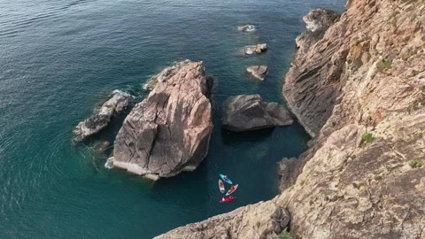 Aerial kayakers by rugged Eo Gio cliffs, Quy Nhon Vietnam Stock Footage 337891553