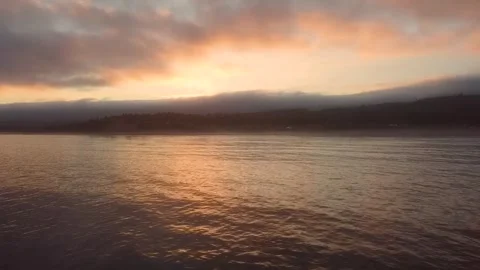 Aerial Lake Bay Sunset Dramatic Orange Sky Cloud Reflection Water Drone Stock Footage 335485132