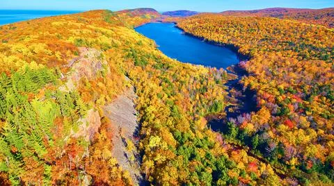 Aerial Lake in the Clouds with fall forest of gold, green, brown, orange and red Stock Photos