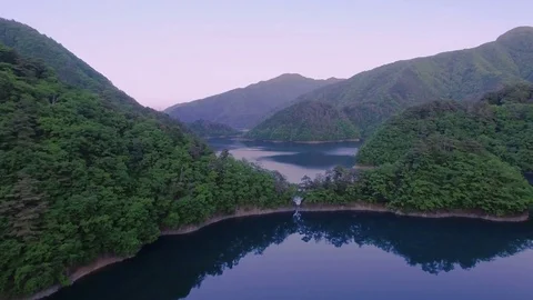 Aerial Lake reflection and Tree covered Hills Stock Footage 73003031