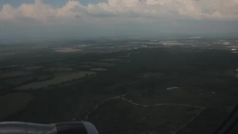 Aerial landscape above green fields and clouds from flight Stock Footage 340400040