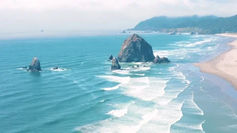 Aerial landscape of Haystack Rock formation on Cannon Beach Oregon Coast Pa.. Video stock 293511703