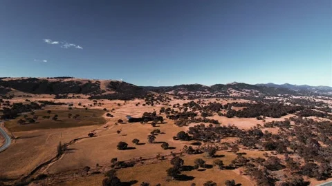 Aerial landscape panning over fields in regional Australia near Tuggeranong, ACT Stock Footage 225360334