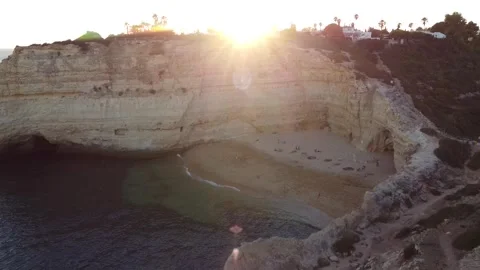 Aerial Landscape Reverse Movement of Beach with Sun Rays Peaking Through Stock Footage 249228049