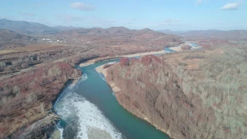 Aerial landscape of the river surrounded by forest on a sunny autumn day with Stock-Footage 152209345
