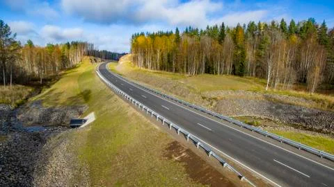 Aerial landscape view of empty rural road in beautiful autumn forest Stock Photos