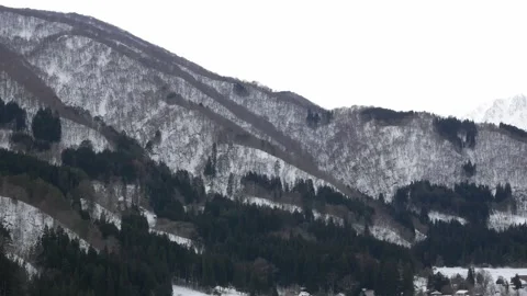 Aerial landscape view of mountain range covered with snow among takayama vall Stock Footage 313037185