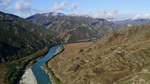 Aerial landscape view of river in valley at foot of mountains in Central Asia Stock Footage 182375308