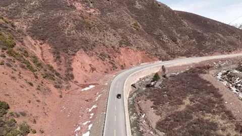Aerial landscape view of road through dry mountain valley in China Stock Footage 337894100