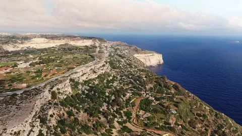 Aerial landscape wide angle panning drone shot over the dingli cliffs and Stock Footage 336431875