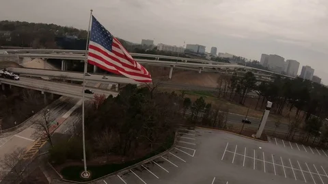 Aerial large american flag blowing in wind Stockbeeldmateriaal 106193853