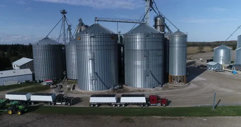 Aerial Of Large Grain Silo Complex Towering Over Trucks And Tractors Look Small 스톡 동영상 199902755