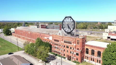 Aerial of a large old clock on the facade of an old abandoned vacant American Stock Footage 164449941