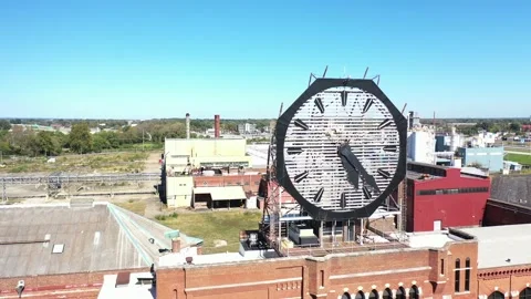 Aerial of a large old clock on the facade of an old abandoned vacant American Stock Footage 164450402