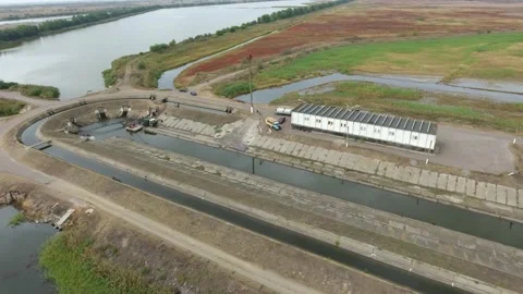 Aerial of a large oval construction with two canals in it shaping fish factory Video stock 144667939