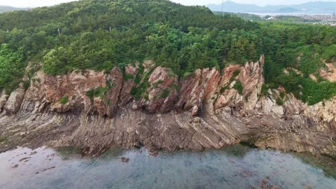 Aerial lateral dolly view of the anticlinal cliffs near Golden pebble beach Stock Footage 314104950