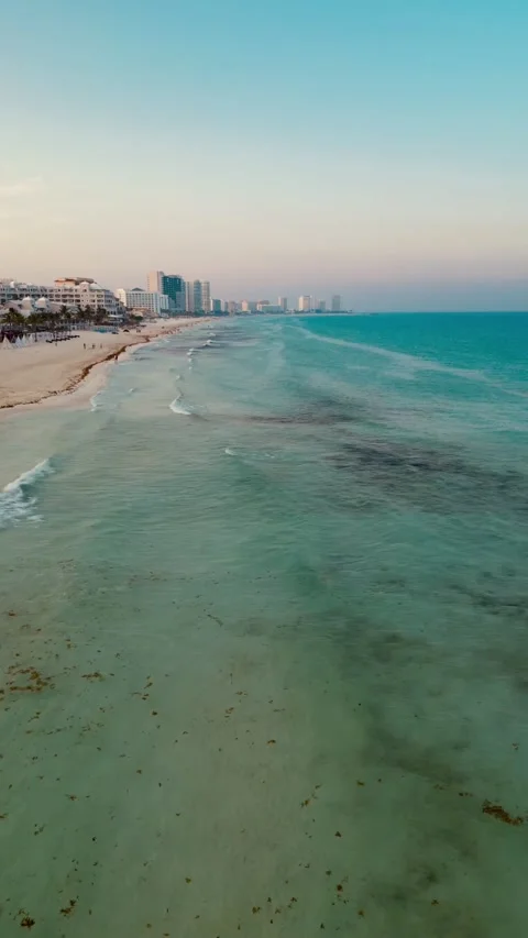 Aerial lateral flight along the Cancun shoreline at dusk Stock-Footage 342090357