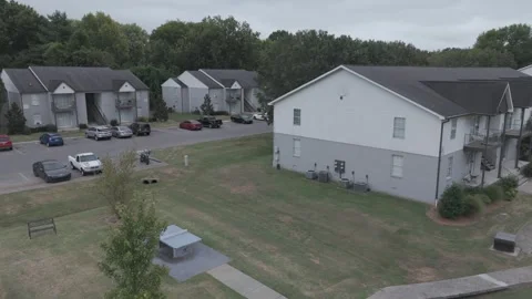 Aerial lateral over apartment complex with fire pit lounge and parking Stock Footage 346732300