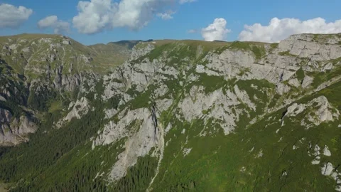 Aerial lateral reveal over the dramatic Gaura Valley in Bucegi Mountains, with s Stock-Footage 324841462