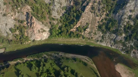 Aerial lateral: River flows below the gorge Stock Footage 114720445
