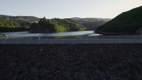 Aerial Lateral View of Dam and Lake at Sunset in French Mountains Stock Footage 315619860