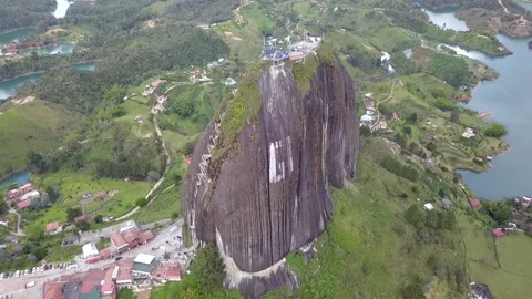 Aerial lateral view of large granite rock Peck of Guatape Stock Footage 133214849