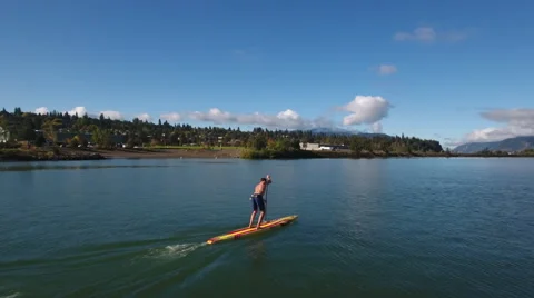 Aerial left to right move around paddle boarder. Stock Footage 68628236
