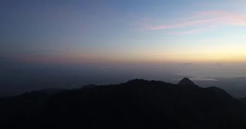Aerial left to right panning view of mountain sunset Stock Footage 81687192