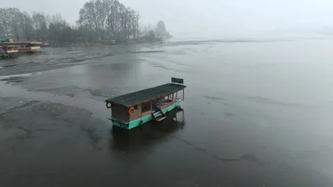 Aerial lens captures the winter isolation of Nageen’s boat dwellers. Stock Footage 311021101