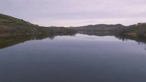 Aerial lift over a calm lake in a remote part of the Arizona desert Stock Footage 167314127