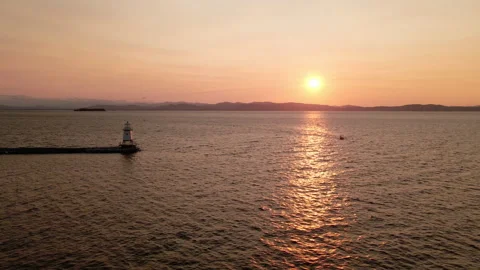 Aerial: Lighthouse at Sunset Stock Footage 141343566
