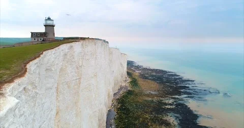 Aerial Lighthouse White Cliffs Ocean England Travel Cinematic Drone Stock Footage 307127223