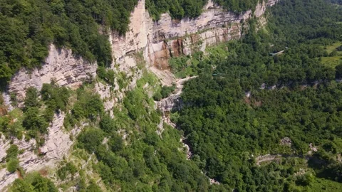 Aerial limestone cliff and waterfall in Svaneti, Georgia gorge Stock Footage 327607460
