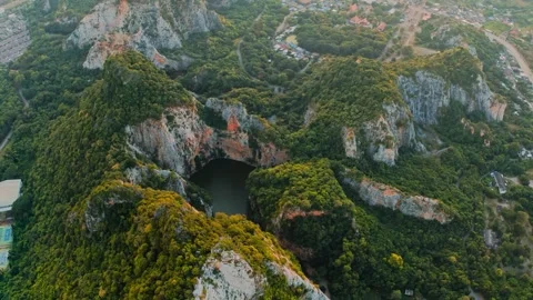 Aerial limestone mountain peaks surrounding a hidden lake Stock Footage 340124845