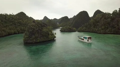 Aerial Of Liveaboard Boat Navigating Through Raja Ampat Islands Video stock 97142908