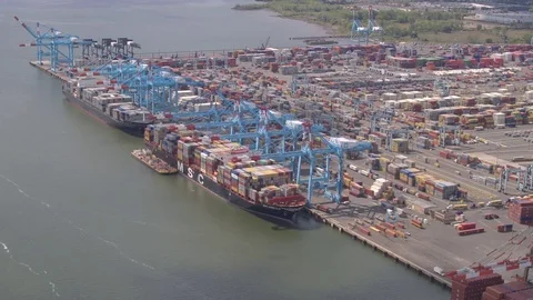 AERIAL: Loading heavy cargo on freighter ship in harbor of New York City port Stock Footage