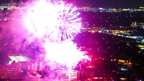 Aerial Lockdown Shot Of Fireworks Bursting In Illuminated City - Culver City, Stock Footage 255409692