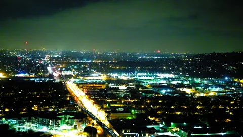 Aerial Lockdown Shot Of Fireworks Exploding In Illuminated City Under Sky At Stock Footage 255409079
