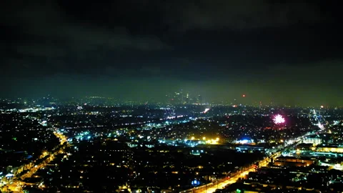Aerial Lockdown Shot Of Fireworks Sparkling In Illuminated City During Night - Stock Footage 255404088