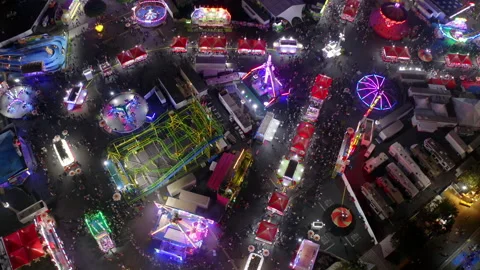 Aerial Lockdown Shot Of People Having Fun At Funfair In City At Night - Costa Stock Footage 188099382