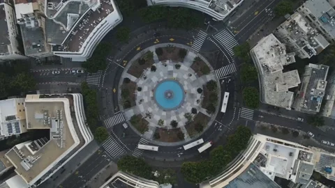 Aerial Lockdown Shot Of Vehicles Moving On Road At Roundabout In City, Drone Stock Footage 238890722