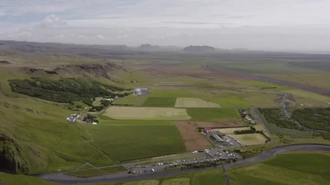 Aerial lockdown shot of vehicles by stream against cloudy sky, drone flying over Stock Footage 129434076