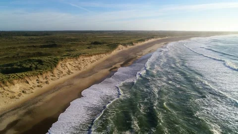 Aerial of a long desolate beach at sunset in the spring Stock Footage 305563618