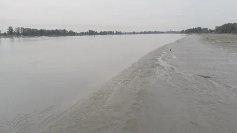 Aerial long flight down the river on an overcast day Stock Footage 128931711