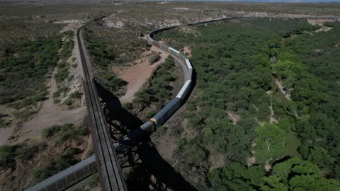 Aerial of a long freight train on an S curved track Stock Footage 194934517