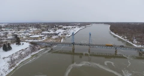 Aerial long high push over drawbridge to small town Stock Footage 86297359