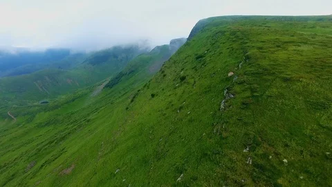Aerial of a long range with flat tops under the low clouds in the Carpathians Stock Footage 91955935