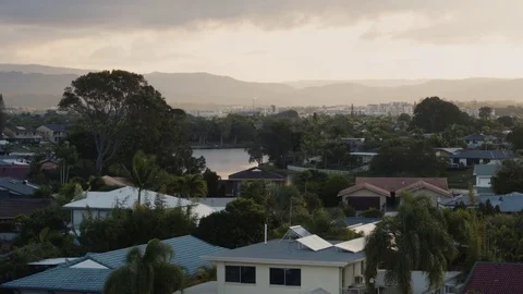 Aerial of long river passing through city settlement at dawn Stock Footage 80999428