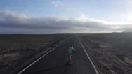 Aerial: Longboarding Towards The Surf Spot Stock Footage